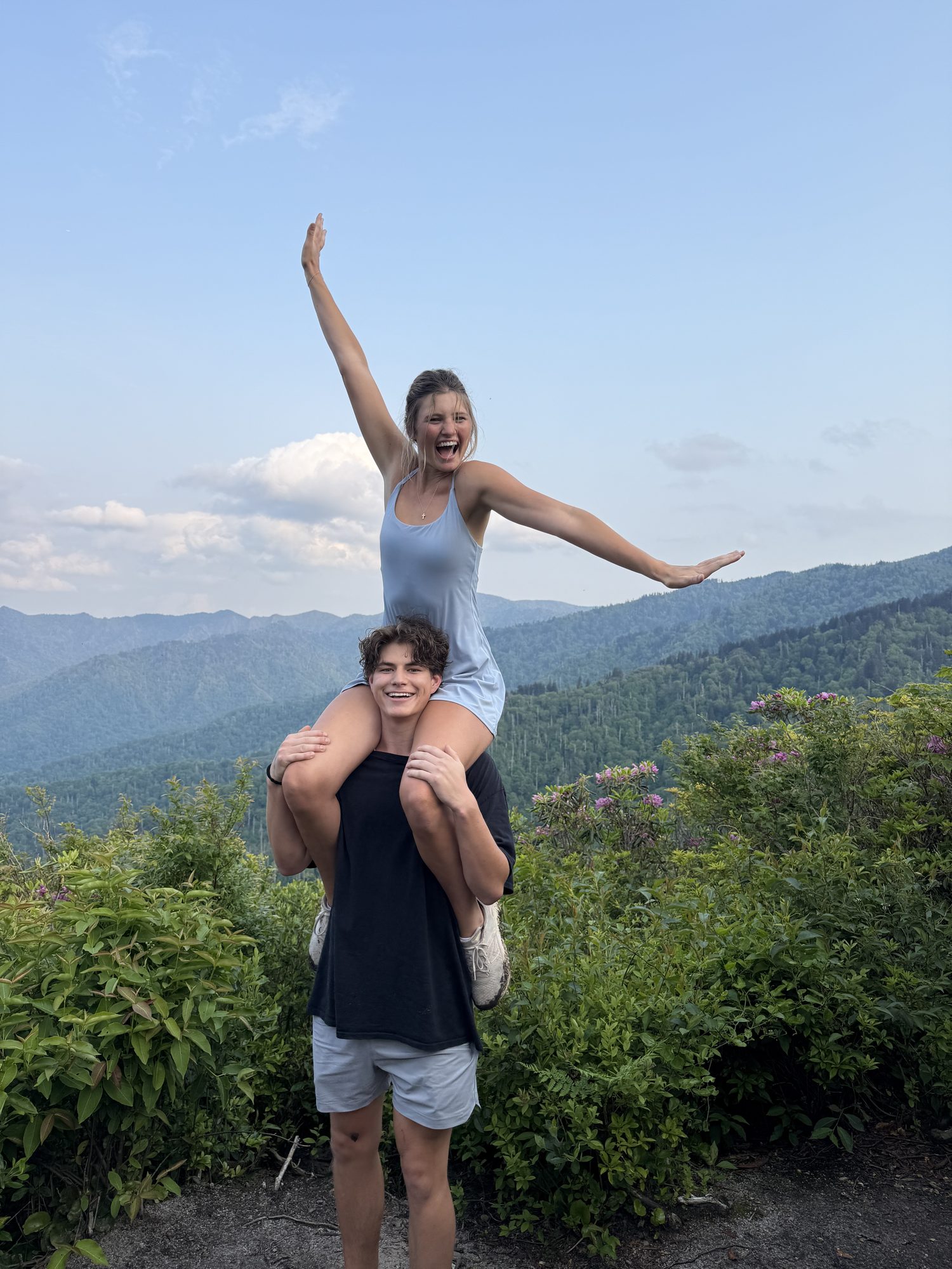 Anna on Brock's shoulders at a mountain overlook